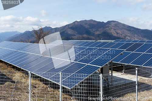 Image of Solar power plant with mountain background