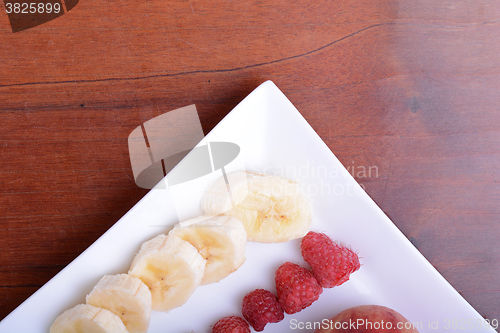 Image of peach raspberries bananas close up as health food concept
