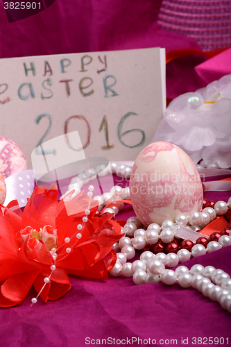 Image of Easter eggs and flowers on background with gift box