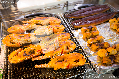 Image of Roasted lobster and scallop at fish market