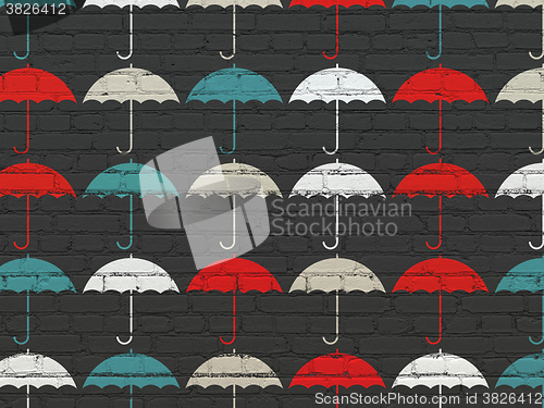 Image of Protection concept: Umbrella icons on wall background