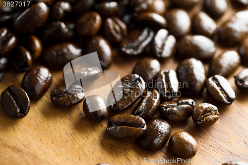 Image of Roasted coffee bean on grunge wood table