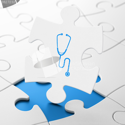 Image of Healthcare concept: Stethoscope on puzzle background