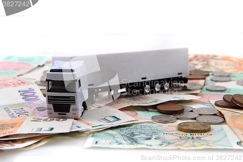 Image of white truck and czech money
