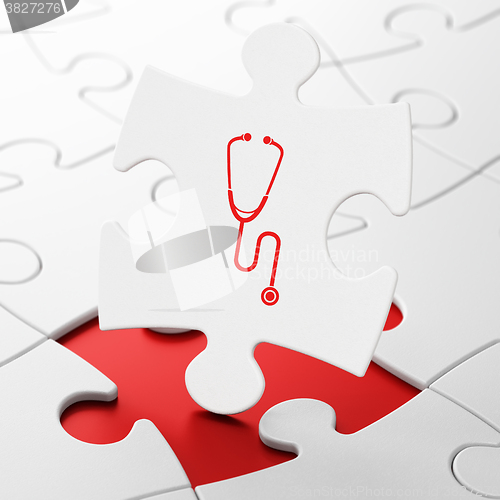 Image of Medicine concept: Stethoscope on puzzle background