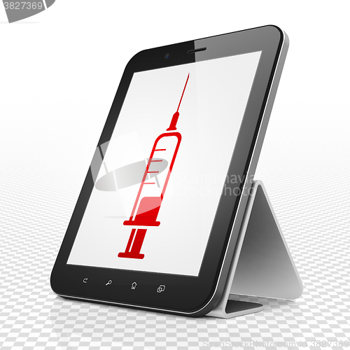 Image of Medicine concept: Tablet Computer with Syringe on display
