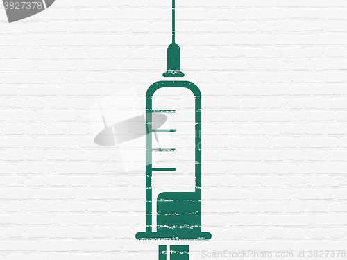 Image of Health concept: Syringe on wall background