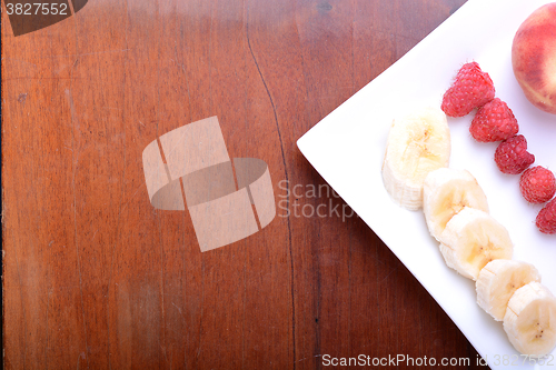 Image of peach raspberries bananas close up as health food concept