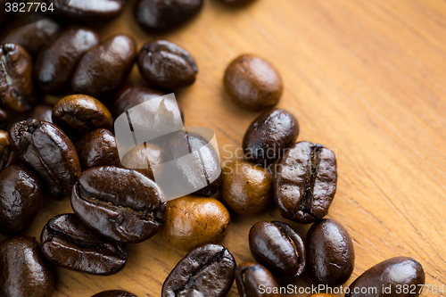 Image of Close up of roasted Coffee bean on wooden table