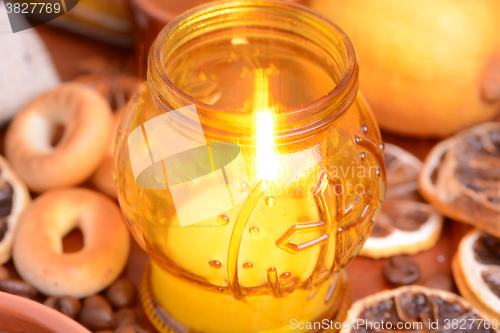 Image of Coffee beans on a black background with candle. Raw coffee beans and fire from candle