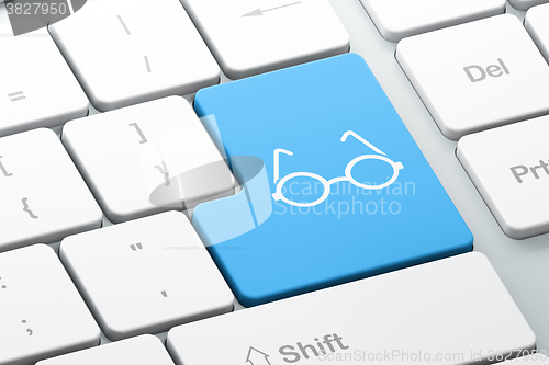 Image of Learning concept: Glasses on computer keyboard background