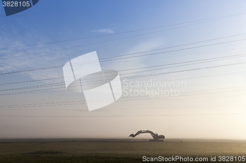 Image of Excavator in a fog 