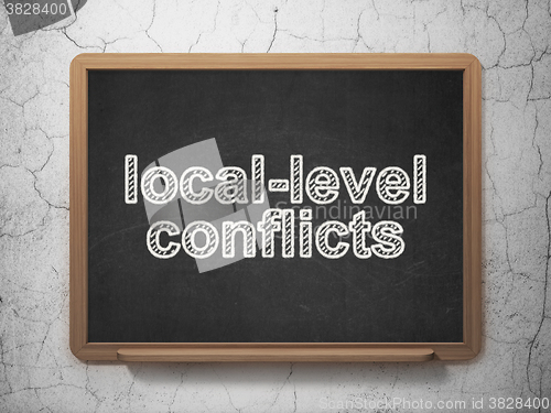 Image of Political concept: Local-level Conflicts on chalkboard background