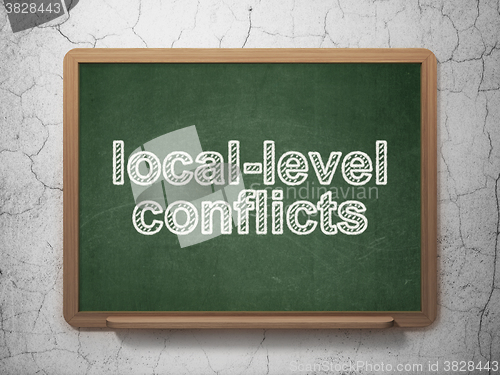 Image of Politics concept: Local-level Conflicts on chalkboard background