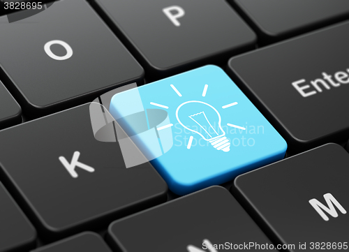 Image of Finance concept: Light Bulb on computer keyboard background