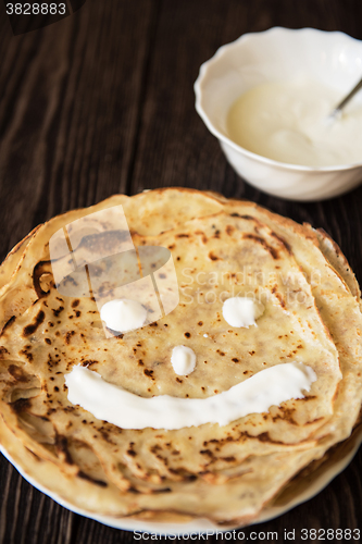 Image of Fried tasty smiling pancakes 