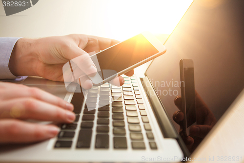 Image of The male hand holding a phone 