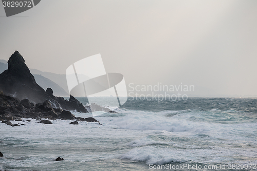 Image of Sea waves rolling on stones