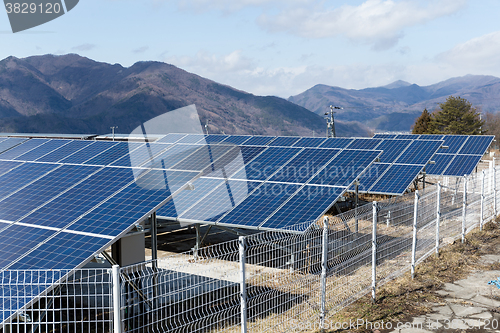 Image of Solar panel with mountain range background