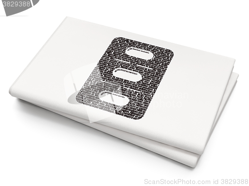 Image of Medicine concept: Pills Blister on Blank Newspaper background