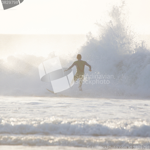 Image of Surfer riding a big wave.