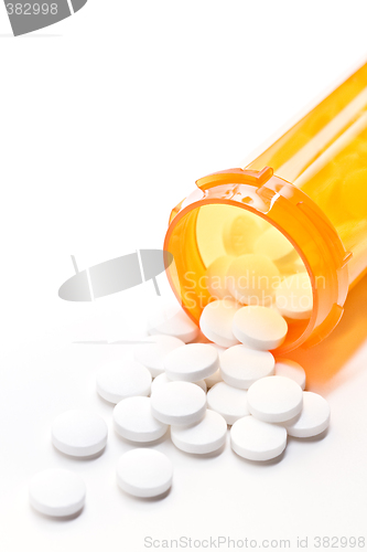Image of pills with bottle on white
