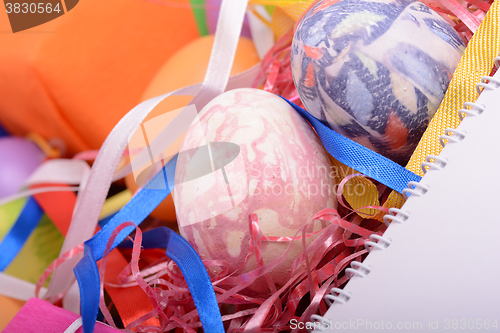 Image of Arrangement of Gift Boxes in Wrapping Paper with Checkered Ribbons and Decorated Easter Eggs