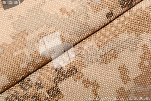 Image of close up of worn out olive green tone camouflage fabric