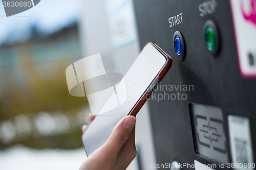 Image of Customer paying though NFC on parking machine