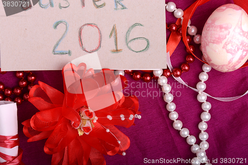 Image of Easter eggs and flowers on background with gift box