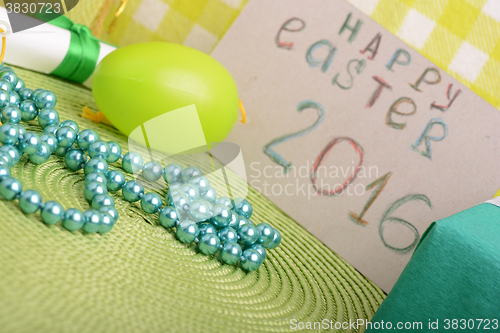 Image of Easter eggs and invitation note. happy easter