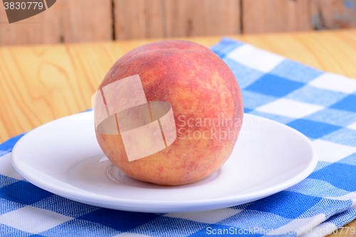 Image of fresh peach on white plate