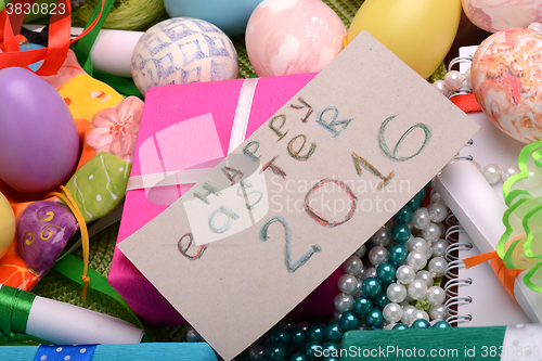 Image of Easter eggs and flowers on background with gift box