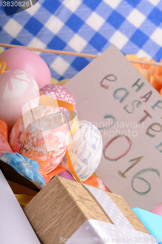 Image of hand made eggs at a gift box, happy easter invitation card