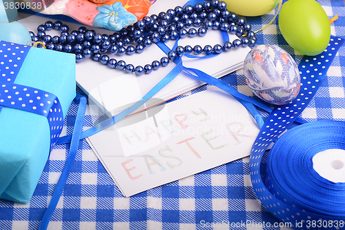 Image of Easter eggs and invitation note. happy easter