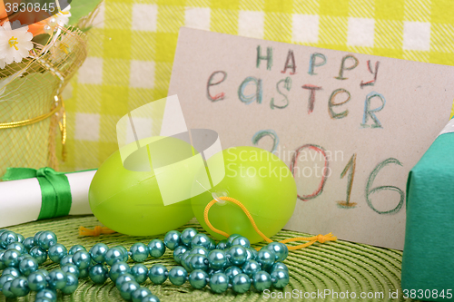 Image of Easter eggs and invitation note. happy easter