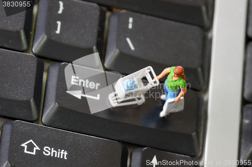 Image of Online shopping with shopper on a keyboard
