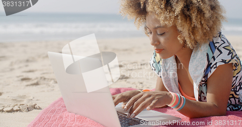 Image of Girl Working On The Sand Beach
