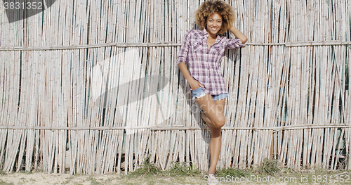 Image of Young Woman Near A Wattled Fence