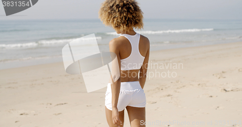 Image of Young Woman Walking On The Beach In Summer