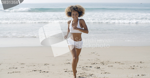 Image of Sporty Woman Running At The Beach
