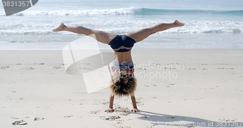 Image of Girl Doing A Handstand On A Beach