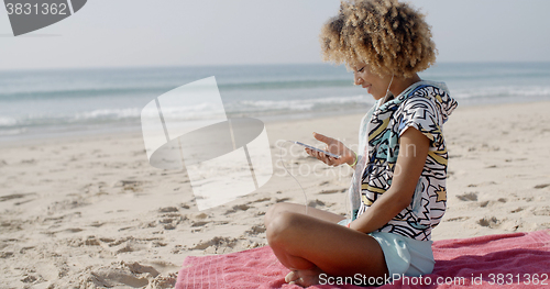 Image of Woman Listening To Music On The Beach