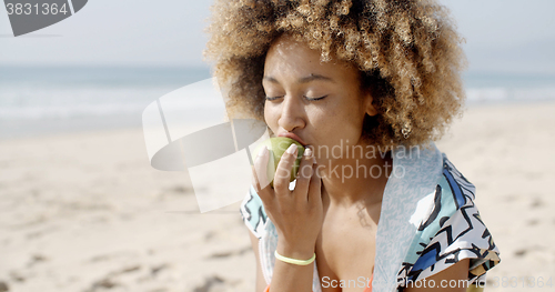Image of Woman Eating A Green Apple 