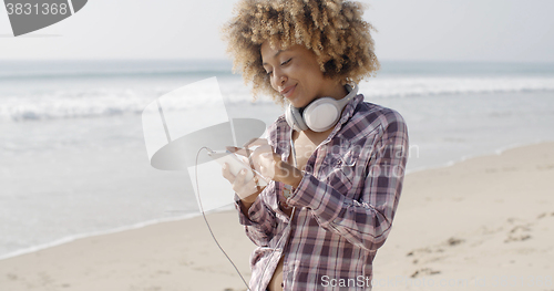 Image of Girl On Beach Listening To Music