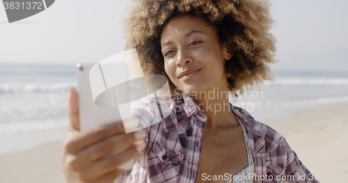 Image of Woman Posing To Take A Selfie On The Beach