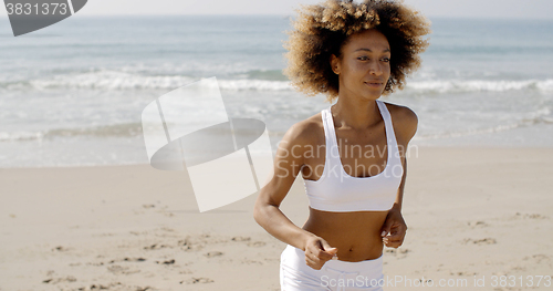 Image of Woman Jogging On The Beach
