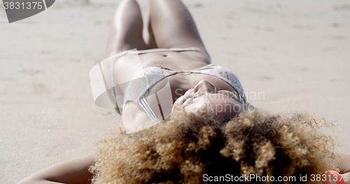 Image of Young Woman Sunbathing In Bikini