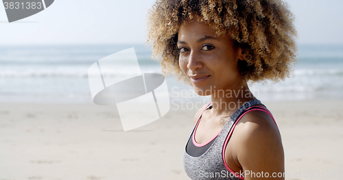 Image of Fit Woman Sits On The Beach
