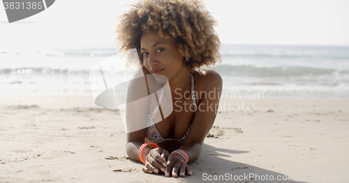 Image of Woman In A Swimsuit Relaxing On The Sand